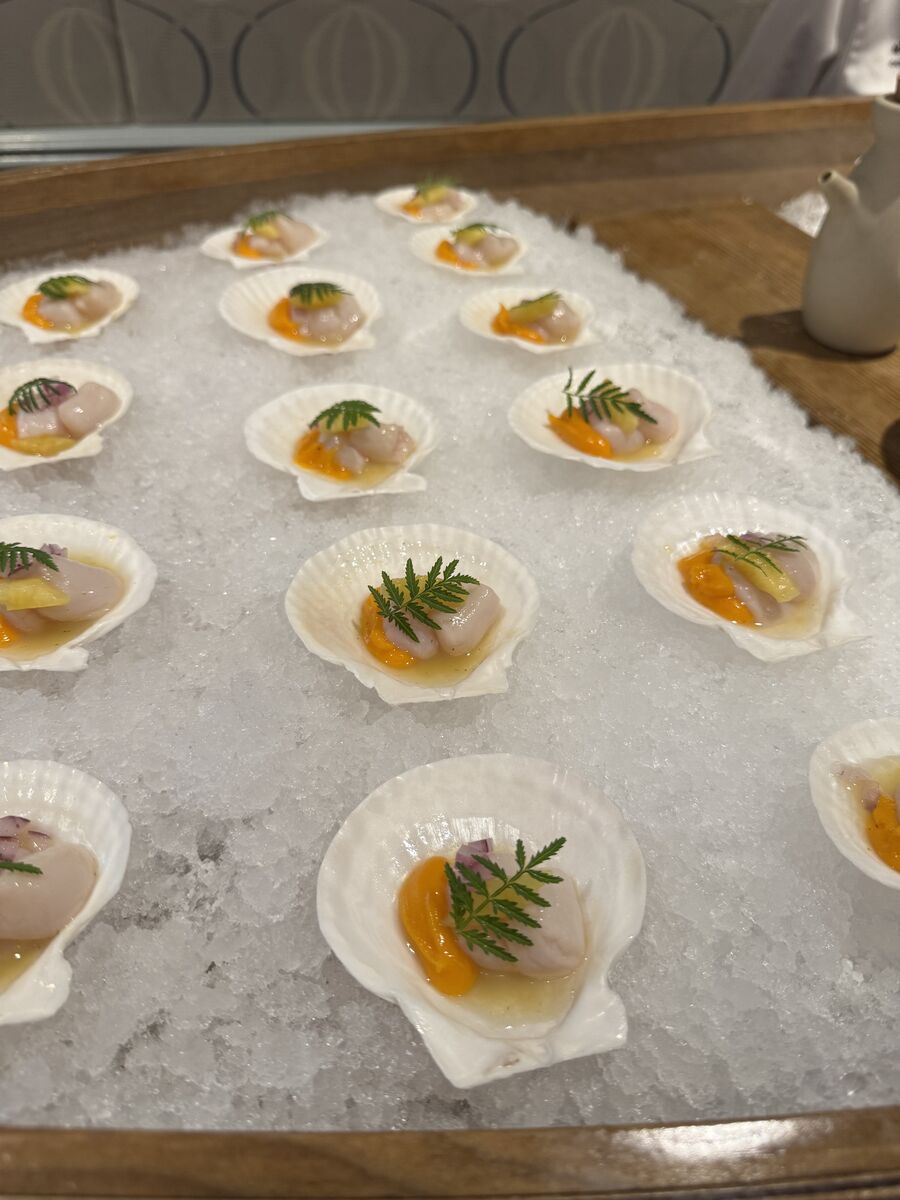 Scallop ceviche with sweet potato roe and pineapple leche de tigre, served in shells on crushed ice